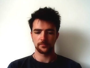 Handsome man is relaxing within doors and shooting himself on web cam