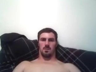 Handsome male is jerking in the guest room and shooting himself on computer webcam