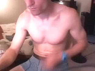 Handsome dude is having a good time at home and filming himself on web camera